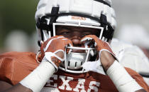 Texas running back Keaontay Ingram adjusts his helmet during a morning practice at the team's facility in Austin, Texas, Wednesday, Aug. 7, 2019. (AP Photo/Eric Gay)