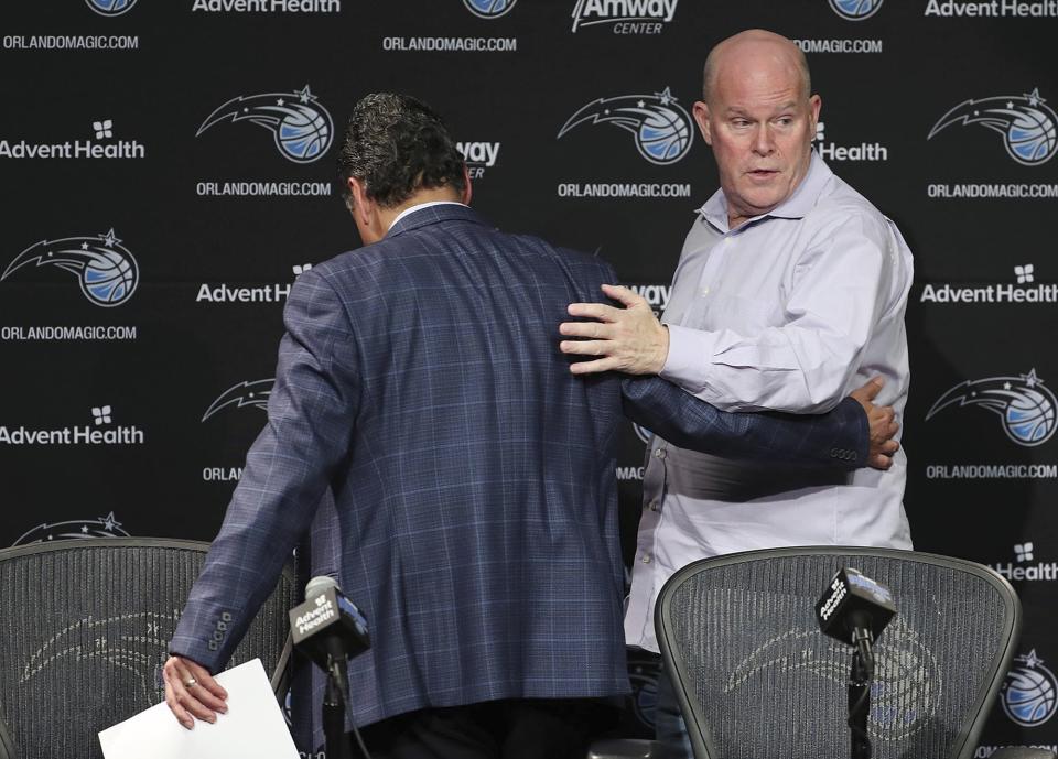 Orlando Magic CEO Alex Martins, left, leads Orlando Magic head coach Steve Clifford off the stage after a press conference at the Amway Center on Thursday, March 12, 2020. The NBA has suspended the season due to the coronavirus. (Stephen M. Dowell/Orlando Sentinel via AP)