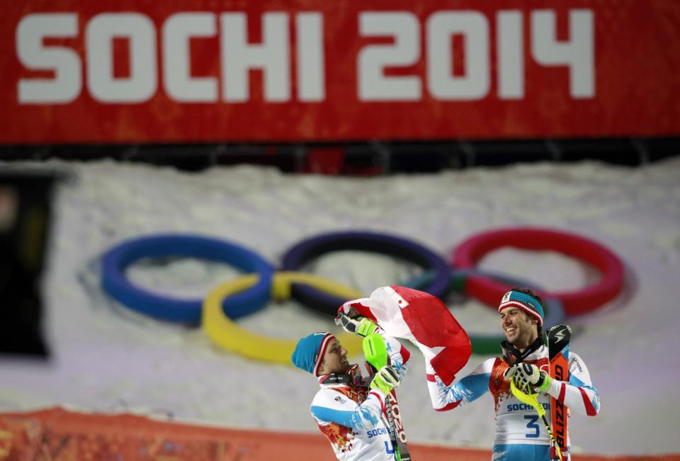 Men's slalom winners Austria's Mario Matt (gold), right, and his teammate Austria's Marcel Hirscher (silver) celebrate on the podium at the Sochi 2014 Winter Olympics, Saturday, Feb. 22, 2014, in Krasnaya Polyana, Russia (AP Photo/Gero Breloer)