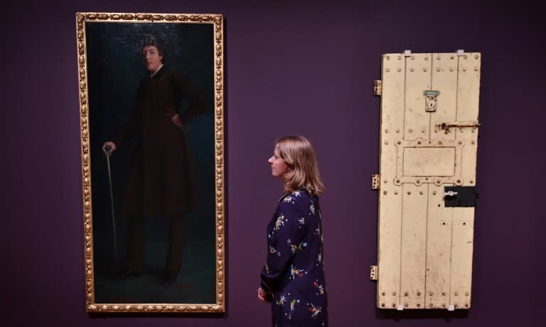 Oscar Wilde's prison door (right) and an oil painting entitled "Oscar Wilde" by US artist Robert Harper are part of the "Queer British Art 1861-1967" exhibition at the Tate Britain in London