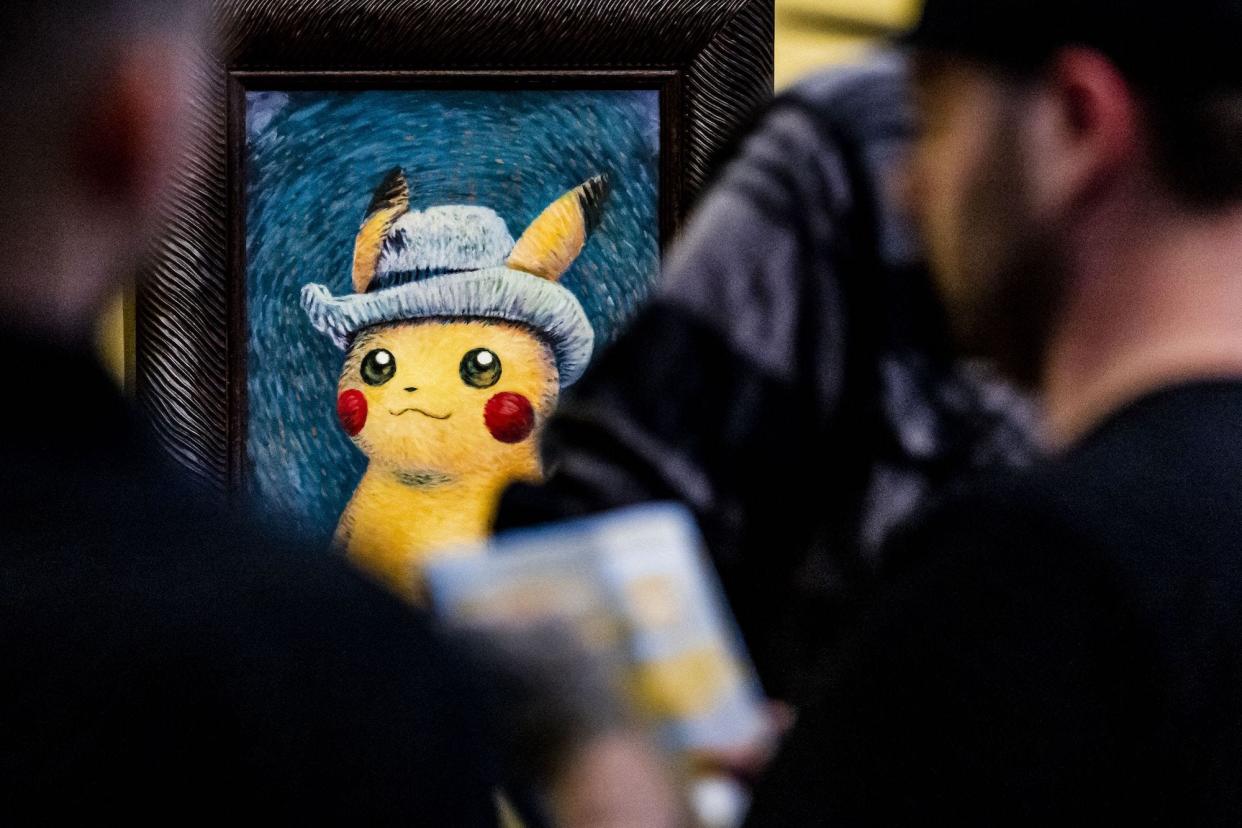 People looking at paintings by artists inspired by Pokemon at the Van Gogh museum in Amsterdam on September 28, 2023.