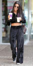 <p>Remember the Juicy velour tracksuits that dominated the early 2000s? Well, Kourtney Kardashian is bringing them back with a sexy twist. The mom of three stepped out in Calabasas, Calif., on Wednesday in a cropped zip-up top and matching drawstring bottoms with big pockets adorning the wide legs. She paired the ab-baring look with slip-on sneakers, a <a rel="nofollow noopener" href="http://shop.nordstrom.com/c/louis-vuitton" target="_blank" data-ylk="slk:Louis Vuitton;elm:context_link;itc:0;sec:content-canvas" class="link ">Louis Vuitton</a> backpack, and round shades (shop a similar pair <a rel="nofollow noopener" href="http://shop.nordstrom.com/s/chloe-62mm-oversize-sunglasses/3742951" target="_blank" data-ylk="slk:here;elm:context_link;itc:0;sec:content-canvas" class="link ">here</a>).</p>