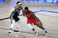 New Orleans Pelicans' Zion Williamson (1) drives to the basket against Sacramento Kings' Richaun Holmes (22) during the second half of an NBA basketball game Thursday, Aug. 6, 2020 in Lake Buena Vista, Fla. (AP Photo/Ashley Landis, Pool)