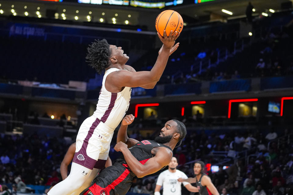 Winston-Salem State guard Jaylen Alston (4) draws the charge from Virginia Union forward Jonathan Salazar (23) during the first half of the HBCU Classic NCAA college basketball game in Indianapolis, Saturday, Feb. 17, 2024. (AP Photo/Michael Conroy