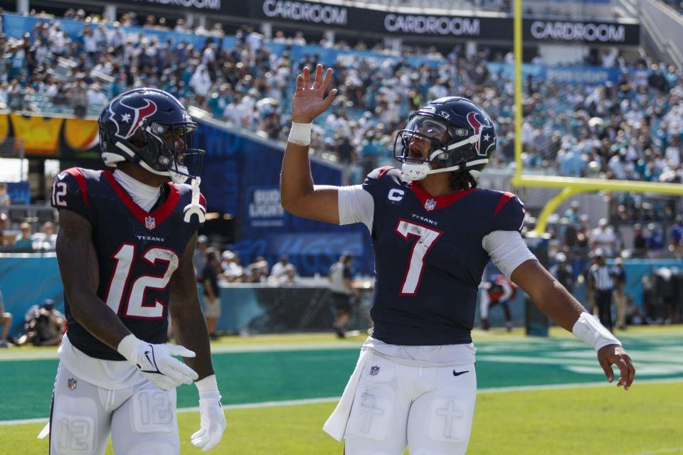 Houston Texans quarterback C.J. Stroud and wide receiver Nico Collins celebrate after a touchdown against the Jacksonville Jaguars.