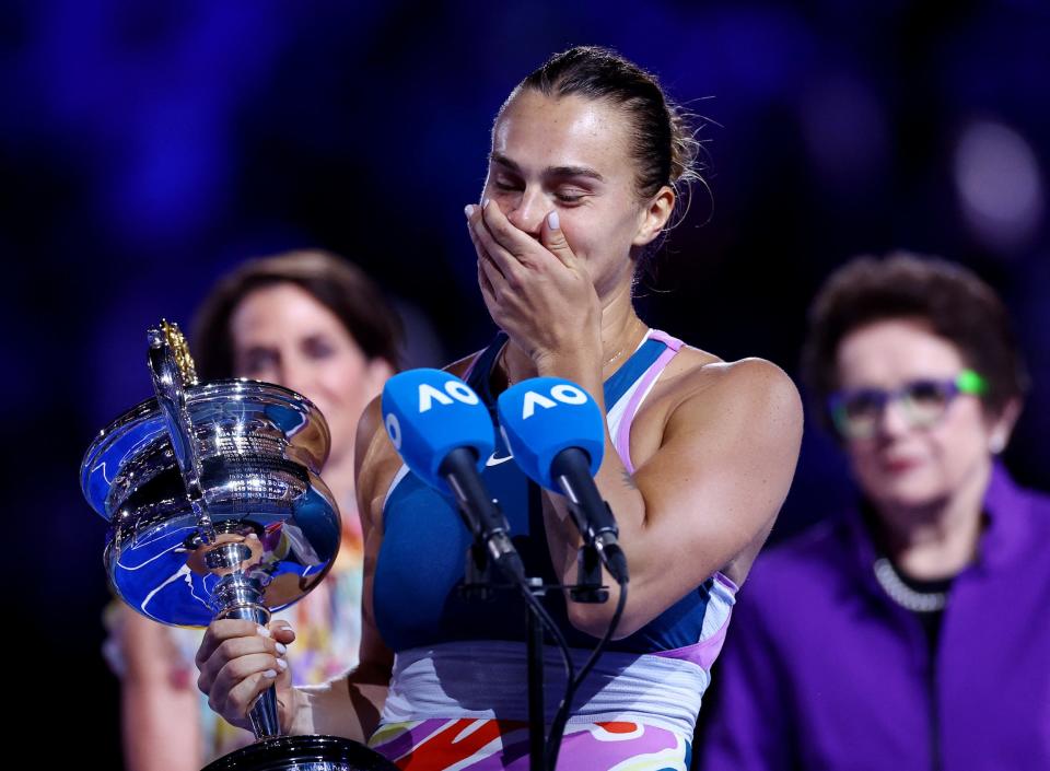 Aryna Sabalenka poses with her trophy from the 2023 Australian Open.