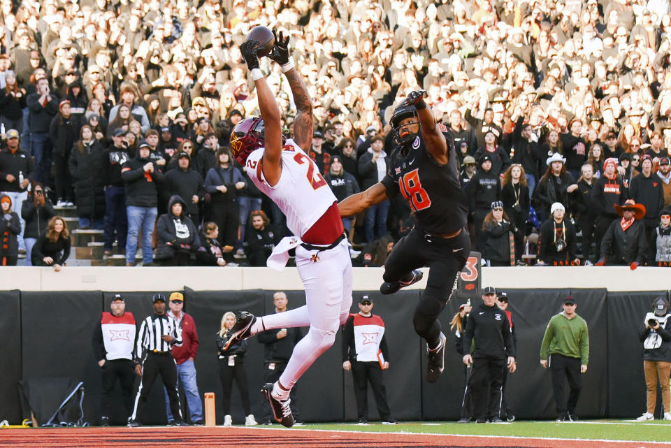 Iowa State wide receiver Sean Shaw Jr. (2) scores a touchdown reception under pressure from Oklahoma State safety Sean Michael Flanagan (18) during the first half of an NCAA college football game Saturday, Nov. 12, 2022, in Stillwater, Okla. (AP Photo/Brody Schmidt)