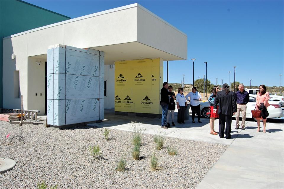 A group that includes U.S. Rep. Teresa Leger Fernandez, members of her staff and members of the San Juan College administration gather outside the new student housing facility being built on the college campus in Farmington on May 5.