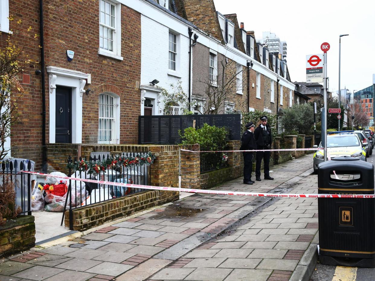Police stand outside the crime scene where Flamur Beqiri, 36, a father of one, was murdered on Christmas Eve: Getty Images