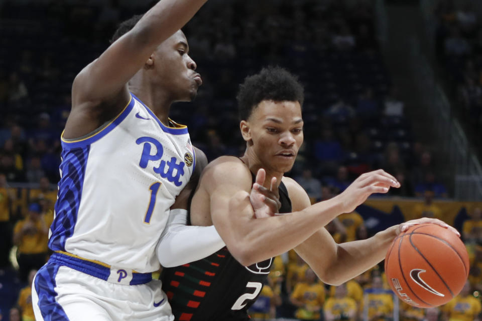 Miami's Isaiah Wong (2) drives past Pittsburgh's Xavier Johnson (1) during the first half of an NCAA college basketball game, Sunday, Feb. 2, 2020, in Pittsburgh. (AP Photo/Keith Srakocic)