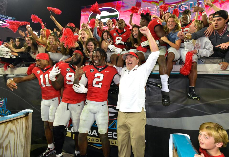 Georgia Bulldogs head coach Kirby Smart celebrates with his players and fans after their victory over Florida last year.