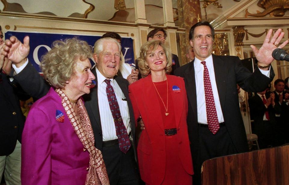 FILE - Mitt Romney, right, chairman of the Boston-based management consulting firm Bain and Company, acknowledges the crowd after announcing his candidacy as a Republican for the U.S. Senate seat held by Sen. Edward Kennedy, D-Mass, in Boston Feb. 2, 1994. With Romney on stage are, from left to right, his mother Lenore Romney, his father George Romney, former governor of Michigan and one-time presidential candidate, and wife Ann. (AP Photo/Jon Chase, File)