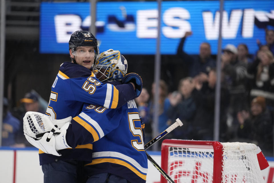 St. Louis Blues' Colton Parayko (55) and goaltender Jordan Binnington celebrate a 2-1 victory over the Vancouver Canucks following an NHL hockey game Thursday, Jan. 4, 2024, in St. Louis. (AP Photo/Jeff Roberson)