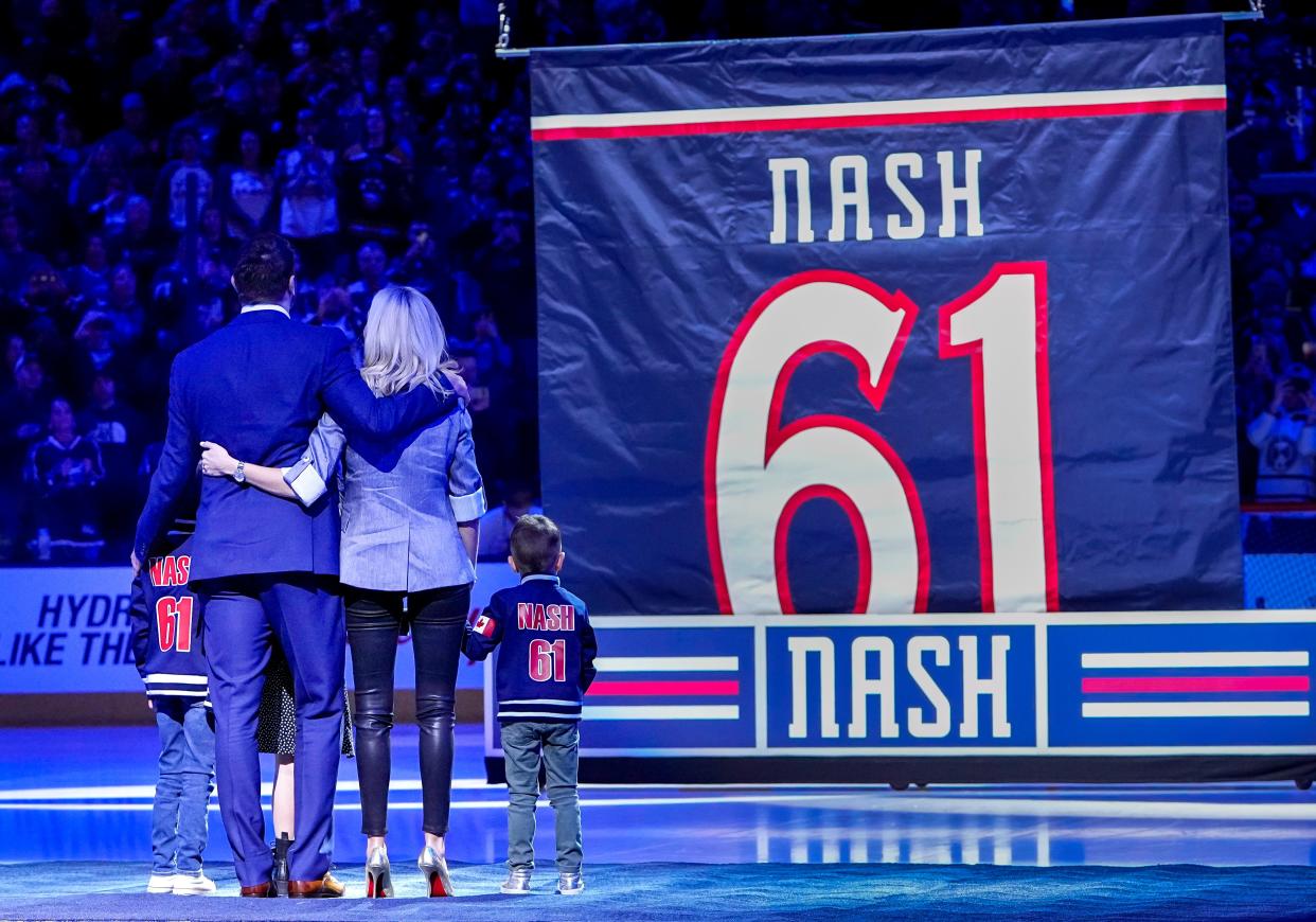 Former Columbus Blue Jackets player Rick Nash and his family watch the banner being raised during his No. 61 jersey retirement ceremony prior to the NHL hockey game against the Boston Bruins at Nationwide Arena in Columbus on March 5, 2022.