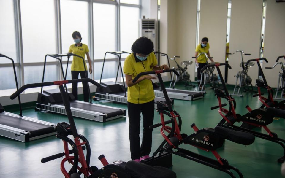 Staff disinfect gym equipment at the Ryugyong Health Complex in Pyongyang - Kim Won Jin/AFP