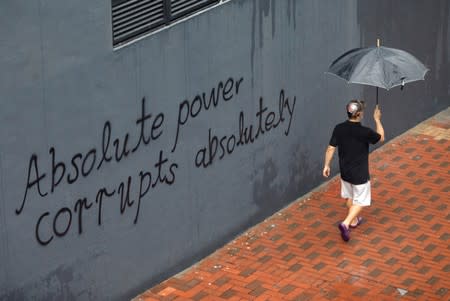 A man walks past a graffiti in Hong Kong