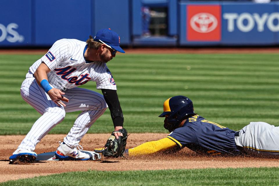 Mar 29, 2024; New York City, New York, USA; Milwaukee Brewers right fielder Jackson Chourio (11) steals second base as New York Mets second baseman Jeff McNeil (1) tags during the first inning at Citi Field. Mandatory Credit: Vincent Carchietta-USA TODAY Sports