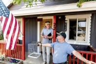 Volunteer firefighter John Hunter, right, describes losing his home and hardware store to the Dixie Fire, Sunday, Sept. 5, 2021, in Quincy, Calif. At left is EmergencyRV.org founder Woody Faircloth, who helped Hunter receive a donated RV. (AP Photo/Noah Berger)