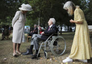 Britain's Camilla, Duchess of Cornwall, speaks to a veteran during the national service of remembrance marking the 75th anniversary of V-J Day at the National Memorial Arboretum in Alrewas, England, Saturday Aug. 15, 2020. Following the surrender of the Nazis on May 8, 1945, V-E Day, Allied troops carried on fighting the Japanese until an armistice was declared on Aug. 15, 1945. (Molly Darlington/PA via AP)