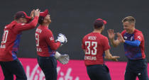 England's Sam Curran, (58) right, celebrates with teammates after running out Sri Lanka's Danushka Gunathilaka, during the second T20 international cricket match between England and Sri Lanka in Cardiff, Wales, Thursday, June 24, 2021. (AP Photo/Alastair Grant)