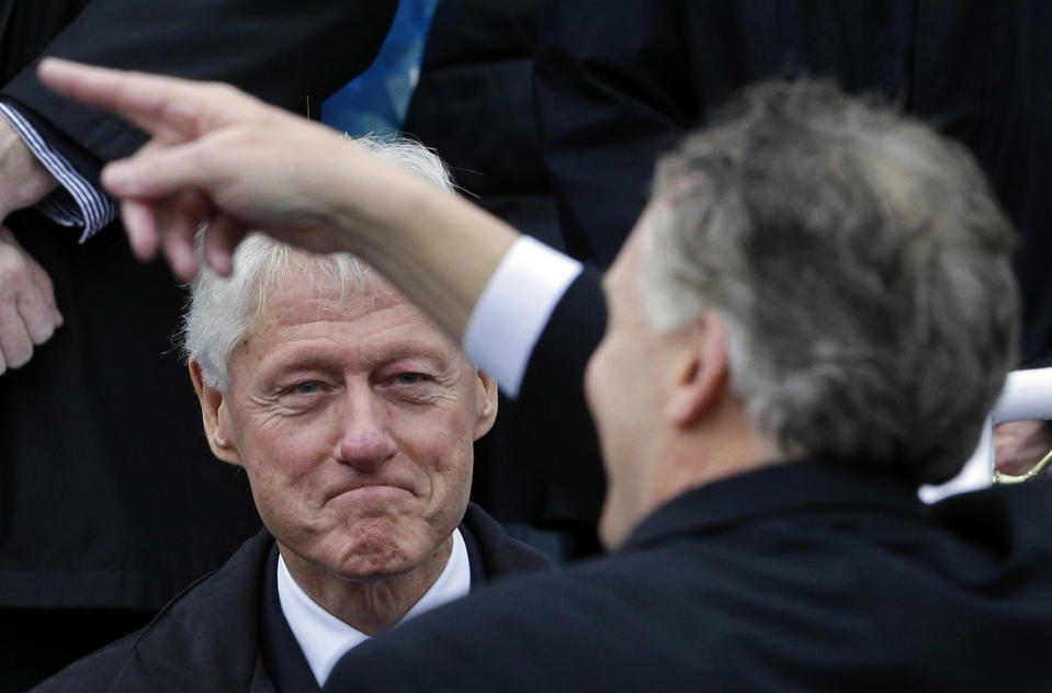 Former President Bill Clinton looks on as Virginia Gov. Terry McAuliffe points to supporters during inaugural ceremonies at the Capitol in Richmond, Va., Saturday, Jan. 11, 2014. McAuliffe is the 72nd governor of Virginia. (AP Photo/Patrick Semansky)