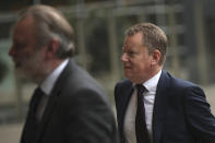 United Kingdom's Brexit envoy David Frost, right, and United Kingdom Ambassador to the European Union Tim Barrow arrive at EU headquarters in Brussels, Wednesday, Oct. 16, 2019. European Union and British negotiators have failed to get a breakthrough in the Brexit talks during a frantic all-night session and will continue seeking a compromise on the eve of Thursday's crucial EU summit. (AP Photo/Francisco Seco)