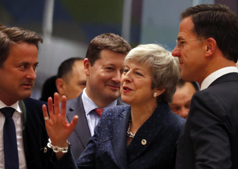 British Prime Minister Theresa May, center, speaks with Dutch Prime Minister Mark Rutte, right, and Luxembourg's Prime Minister Xavier Bettel, left, during a round table meeting at an EU summit in Brussels, Thursday, March 21, 2019. British Prime Minister Theresa May is trying to persuade European Union leaders to delay Brexit by up to three months, just eight days before Britain is scheduled to leave the bloc. (AP Photo/Frank Augstein)