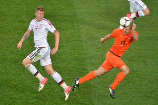 Danish forward Nicklas Bendtner (L) fights for the ball with Dutch defender Ron Vlaar during the Euro 2012 football match in Kharkiv. Denmark won 1-0