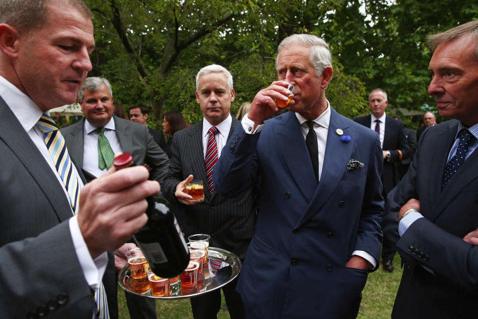 LONDON, ENGLAND - SEPTEMBER 11:  Prince Charles, Prince of Wales samples beer during a reception to celebrate the 21st anniversary of Duchy originals products at Clarence House on September 11, 2013 in London, England. The reception was held in the gardens of Clarence House, and attended by Duchy suppliers, Waitrose and other international stockists, customers, charitable beneficiaries and representatives of some of the charities who benefit from the sale of the products.  (Photo by Dan Kitwood - WPA Pool/Getty Images)