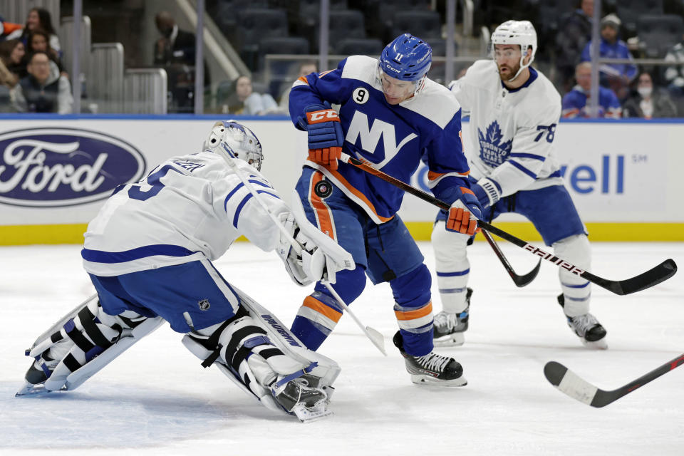 Toronto Maple Leafs goaltender Petr Mrazek makes a save in front of New York Islanders left wing Zach Parise in the second period of an NHL hockey game Saturday, Jan. 22, 2022, in Elmont, N.Y. (AP Photo/Adam Hunger)
