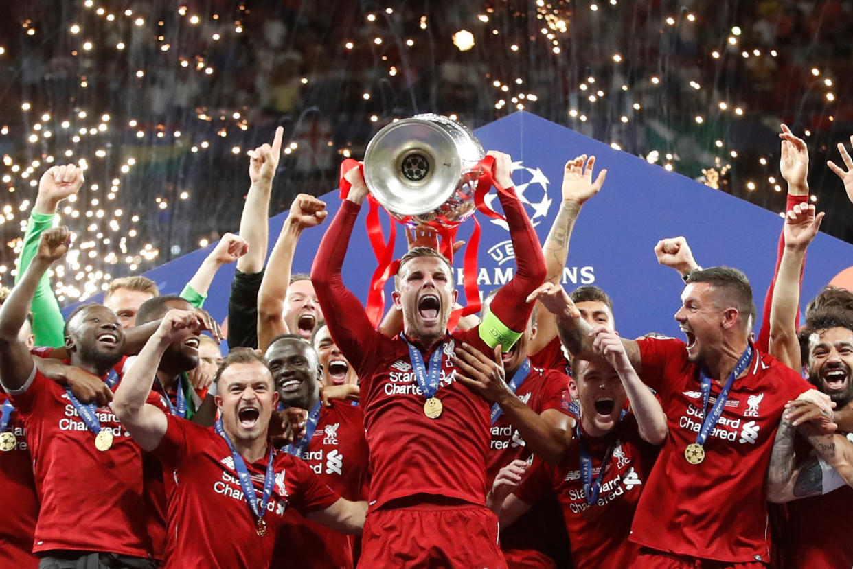 Soccer Football - Champions League Final - Tottenham Hotspur v Liverpool - Wanda Metropolitano, Madrid, Spain - June 1, 2019  Liverpool's Jordan Henderson celebrates with the trophy and teammates after winning the Champions League Final  REUTERS/Carl Recine     TPX IMAGES OF THE DAY