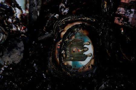 Partially burnt dvd's are seen inside a gutted house after a fire at a residential district in Pasig, Metro Manila, Philippines, May 5, 2018. REUTERS/Erik De Castro