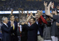 Boston Red Sox chairman Tom Werner holds the championship trophy as president Sam Kennedy, third from right, manager Alex Cora, second from right, and pitcher Chris Sale, right, celebrate after Game 5 of baseball's World Series against the Los Angeles Dodgers on Sunday, Oct. 28, 2018, in Los Angeles. The Red Sox won 5-1 to win the series 4 game to 1. At left is MLB commissioner Rob Manfred. (AP Photo/David J. Phillip)