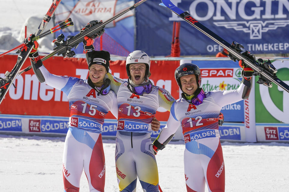 Norway's Lucas Braathen, center, winner of alpine ski, men's World Cup giant slalom, poses with second placed Switzerland's Marco Odermatt, left, and third placed Switzerland's Gino Caviezel, in Soelden, Austria, Sunday, Oct. 18, 2020. (AP Photo/Giovanni Auletta)