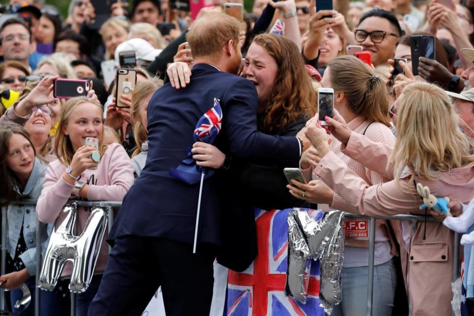 The Duke of Sussex hugs India Brown at the Royal Botanic Gardens in Melbourne (PA)