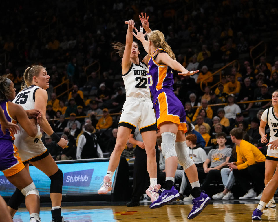 Iowa guard Caitlyn Clark (22) shoots the ball over UNI center Cynthia Wolf (30) during the game at Carver-Hawkeye Arena in Iowa City on Sunday, Dec. 18, 2022. The Hawkeyes defeated the Panthers, 88-74.