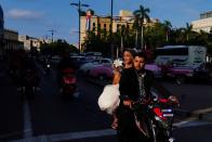 Bride and groom opt for electric motorcycles instead of limos amidst fuel shortage in Cuba