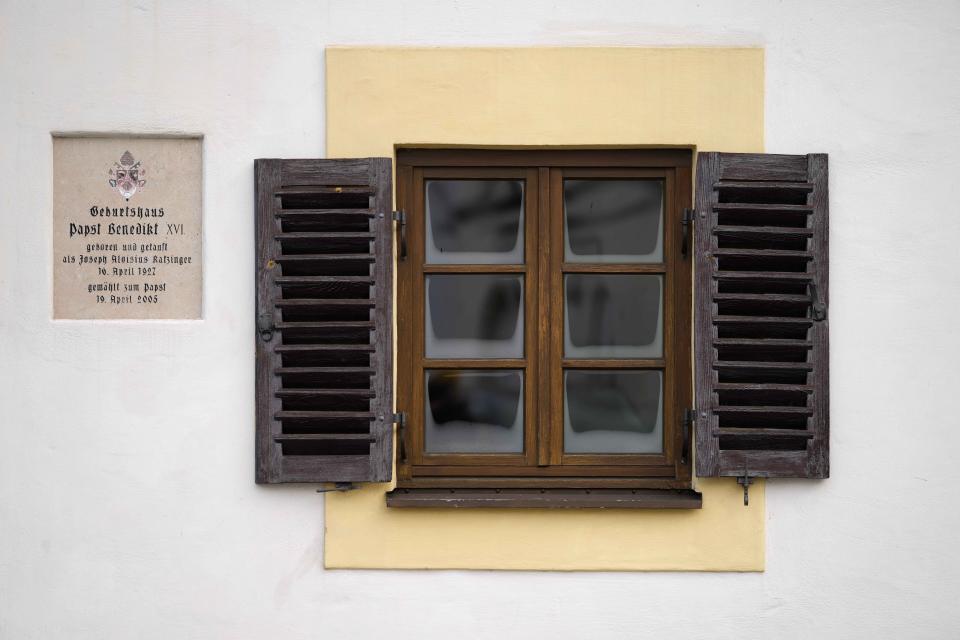 A memorial plaque is fixed at the birthplace of Pope emeritus Benedict XVI in Marktl, Germany, Thursday, Dec. 29, 2022. The health of Pope Emeritus Benedict XVI has worsened due to his age, and doctors are constantly monitoring the 95-year-old's condition, the Vatican said Wednesday.(AP Photo/Matthias Schrader)