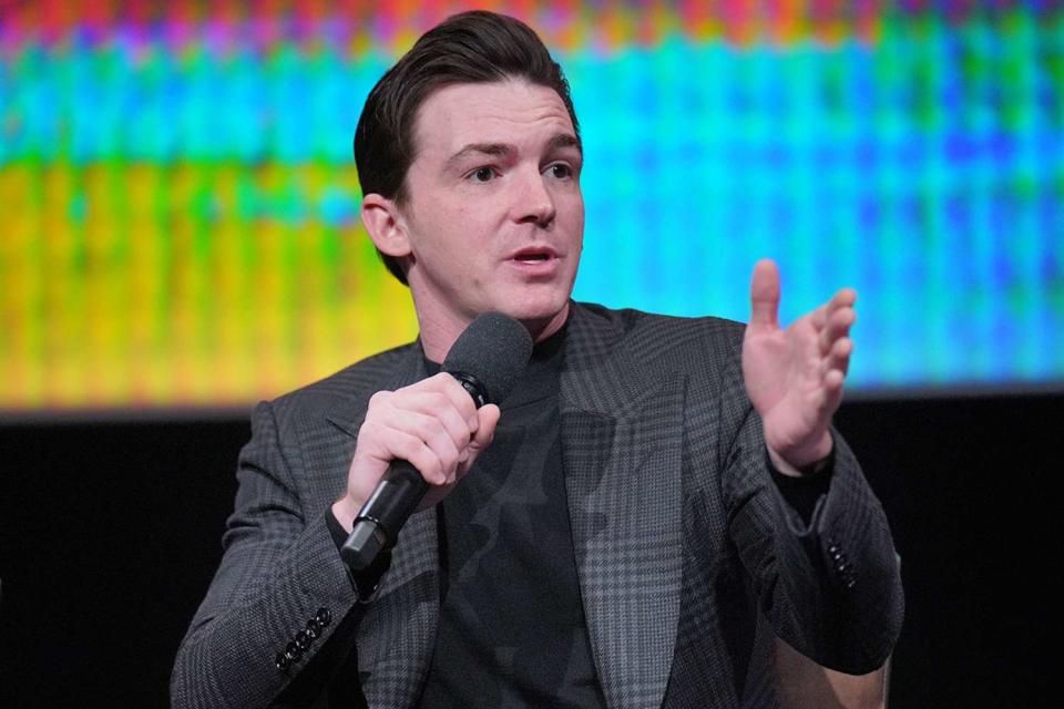 <p>Gonzalo Marroquin/Getty Images</p> Drake Bell speaks during the <em>Quiet On Set: The Dark Side of Kids TV</em> panel in Los Angeles on April 9, 2024