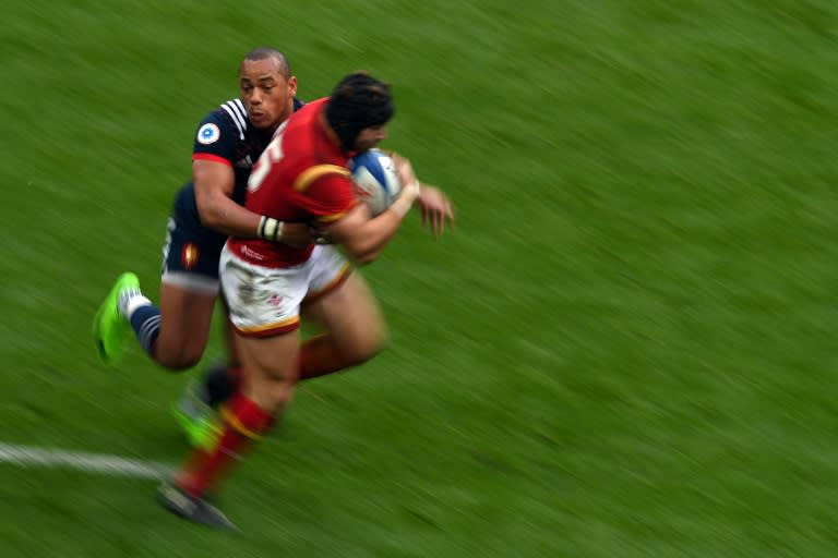 Gael Fickou France's centre (L) tackles Wales' full-back Leigh Halfpenny during the Six Nations tournament Rugby Union match March 18, 2017