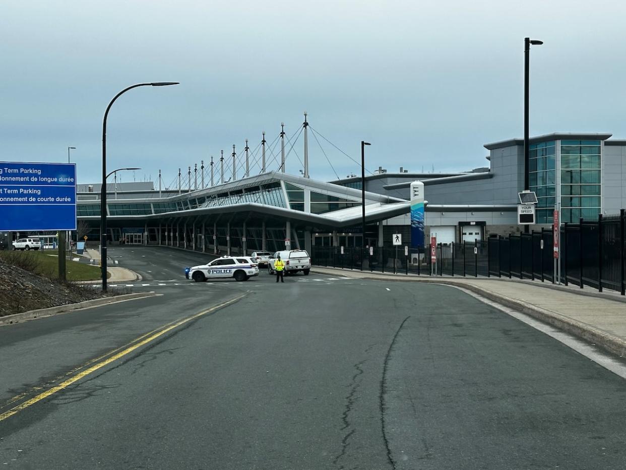 Police vehicles were stationed outside St. John's International Airport on Monday morning in response to a suspicious package reported inside. (Jessica Singer/CBC - image credit)