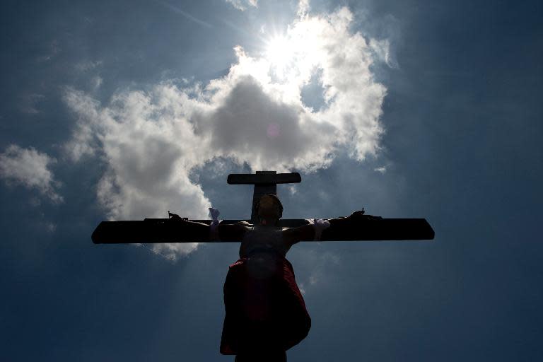 A Filipino Roman Catholic devotee is nailed to a cross during the a re-enactment of the Crucifixion of Christ during Good Friday celebrations ahead of Easter in the village of Santa Lucia, Pampanga, north of Manila, on April 18, 2014