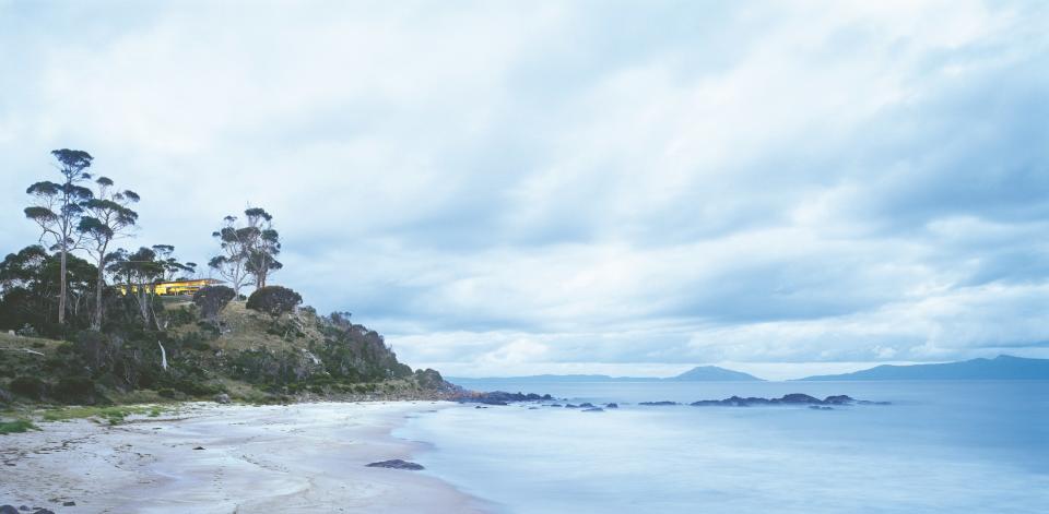 The owner of Avalon Coastal Retreat, Brett Torossi, spent five years searching for the perfect location and architect to build a modern seaside retreat. She found the ideal spot on the east coast of Tasmania, overlooking Great Oyster Bay, and hired Rosevear Architects to create the three-bedroom, three bath home, which is decorated with furniture and artwork commissioned from Tasmania and around the world.