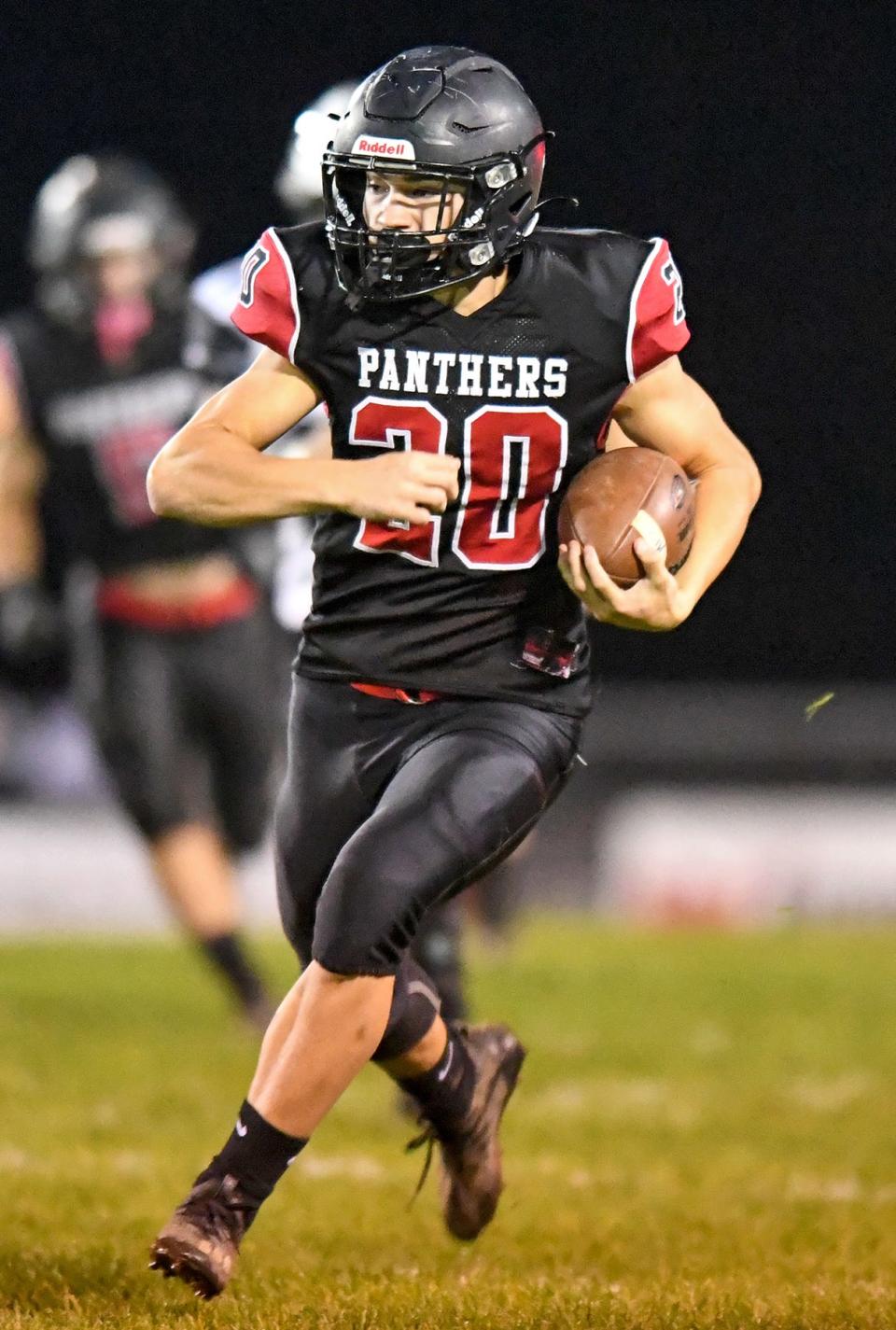 Manchester’s Cooper Briggs (20) carries the ball to score a 75-yard touchdown in the first half of Saturday’s game against Edison. (NICK CAMMETT/BEACON JOURNAL)