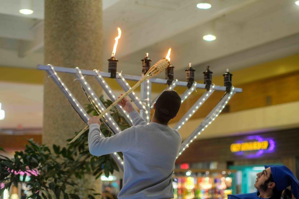 The menorah is lit at Westgate Mall to celebrate Hanukkah  Thursday during the "Roving Rabbis" visit to Amarillo.