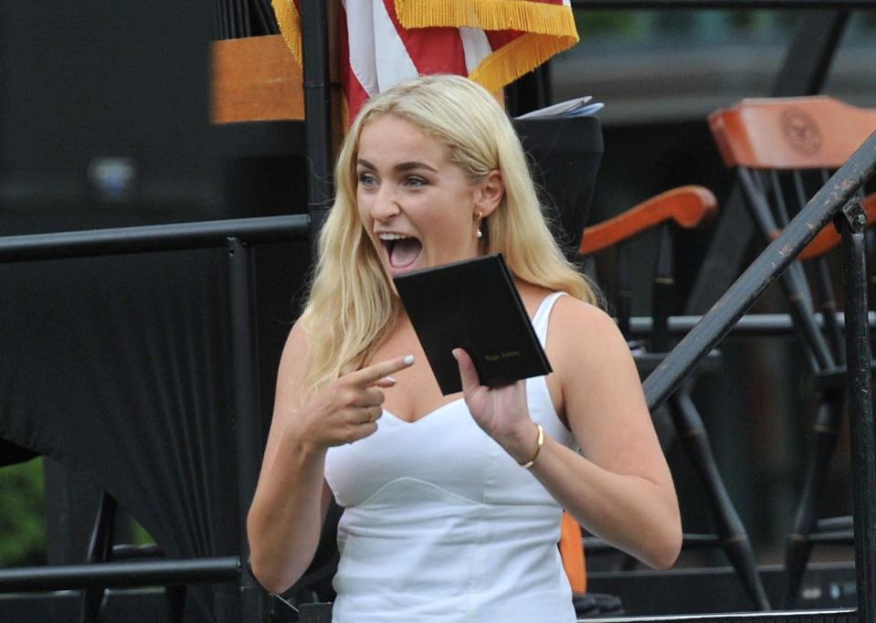 Eliza Farley points to her diploma during the Thayer Academy commencement in Braintree on Saturday, June 10, 2023.