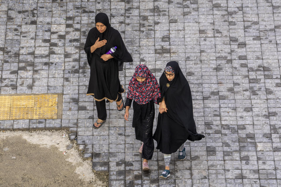 Kashmiri Shiite Muslim women arrive to participate in a Muharram procession in Srinagar, Indian controlled Kashmir, Thursday, July 27, 2023. Muharram is a month of mourning for Shiite Muslims in remembrance of the martyrdom of Imam Hussein, the grandson of the Prophet Muhammad. (AP Photo/Dar Yasin)