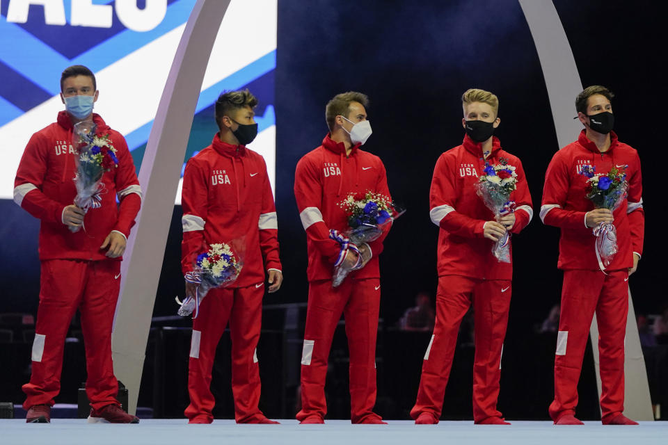 Members of the US Men's Olympic Team, Brody Malone, Yul Moldauer, Sam Mikulak and Shane Wiskus plus individual member Alec Yoder (L-R) stand on stage after the men's U.S. Olympic Gymnastics Trials Saturday, June 26, 2021, in St. Louis. (AP Photo/Jeff Roberson)