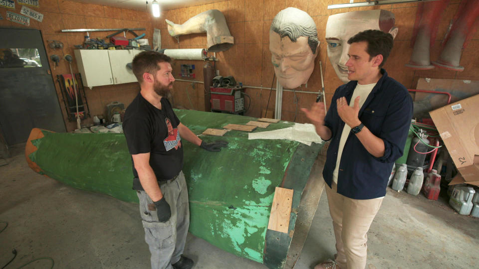 Michael Younkin, who helps restore the fiberglass giants, with correspondent Conor Knighton. / Credit: CBS News