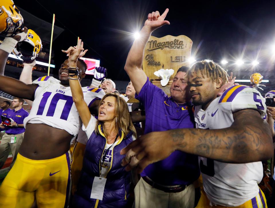 LSU head coach Ed Orgeron celebrates with running back Derrius Guice (5) following their 40-24 win over Mississippi in an NCAA college football game in Oxford, Miss., Saturday, Oct. 21, 2017. (AP Photo/Rogelio V. Solis)